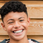 smiling young man with braces